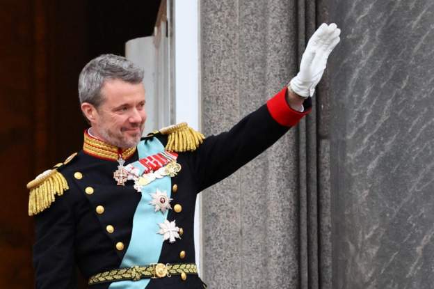 King Frederik X waves to the people after being proclaimed by prime minister on palace balcony